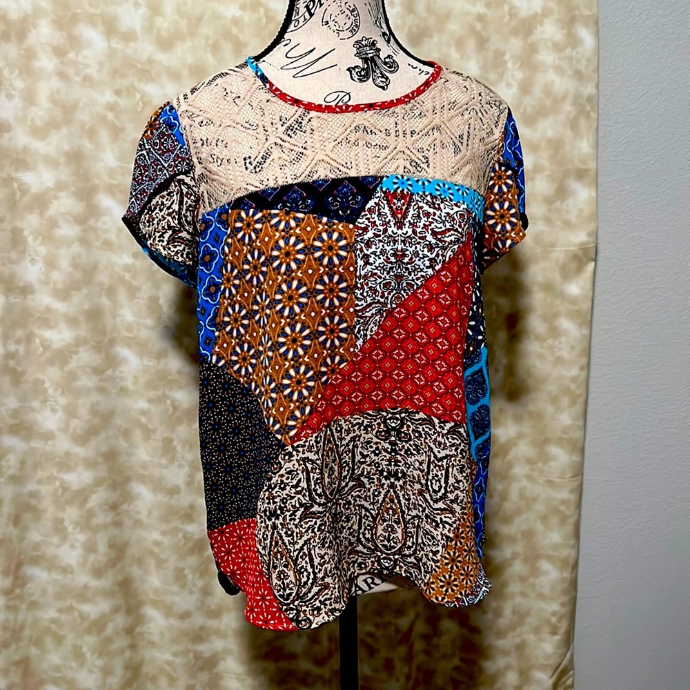 Short sleeve multi color blouse. Asymmetrical. Light material.